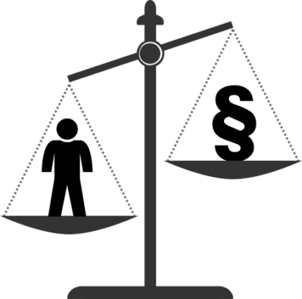 Image of scale weighing human against law section code