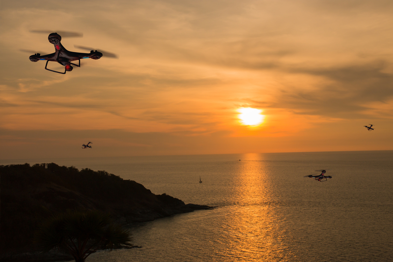 Drones hovering over ocean view