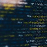 Image of computer coding. Some of the coding is blurred.